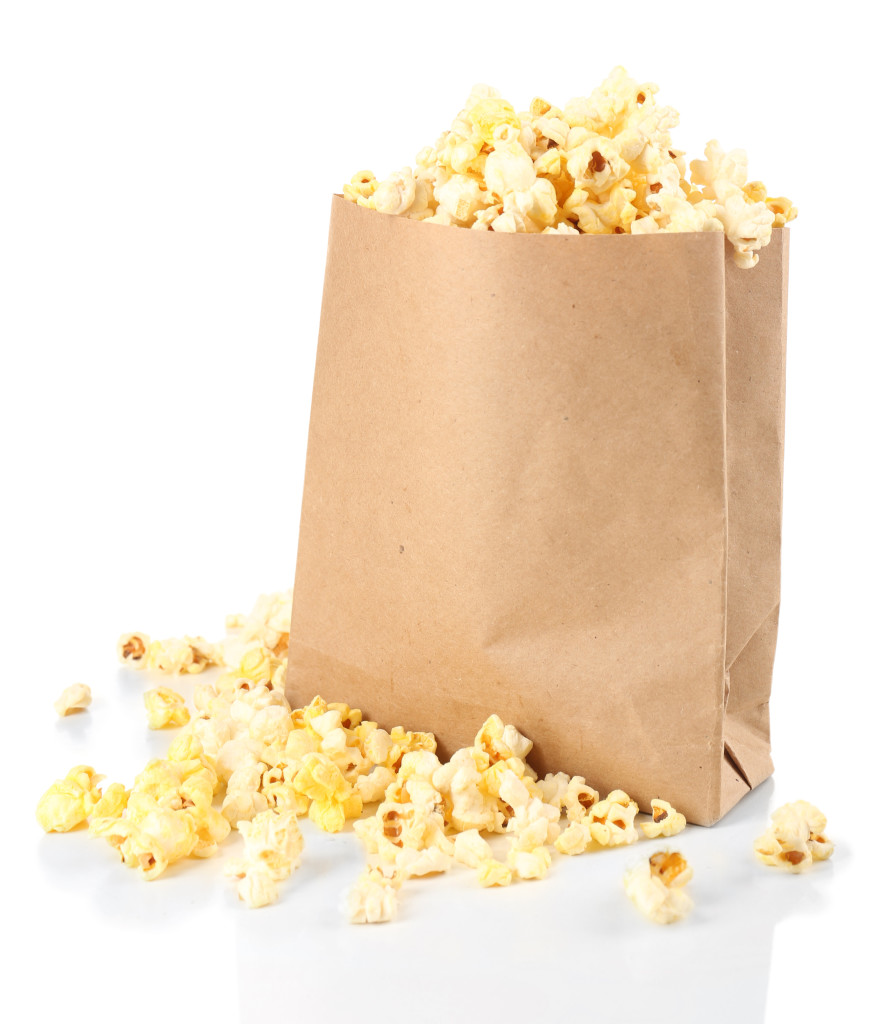 Popcorn in paper bag isolated on white http://cleanfoodcrush.com/diy-popcorn-bags