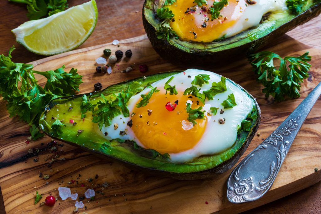 Avocado topped with egg and spring onions