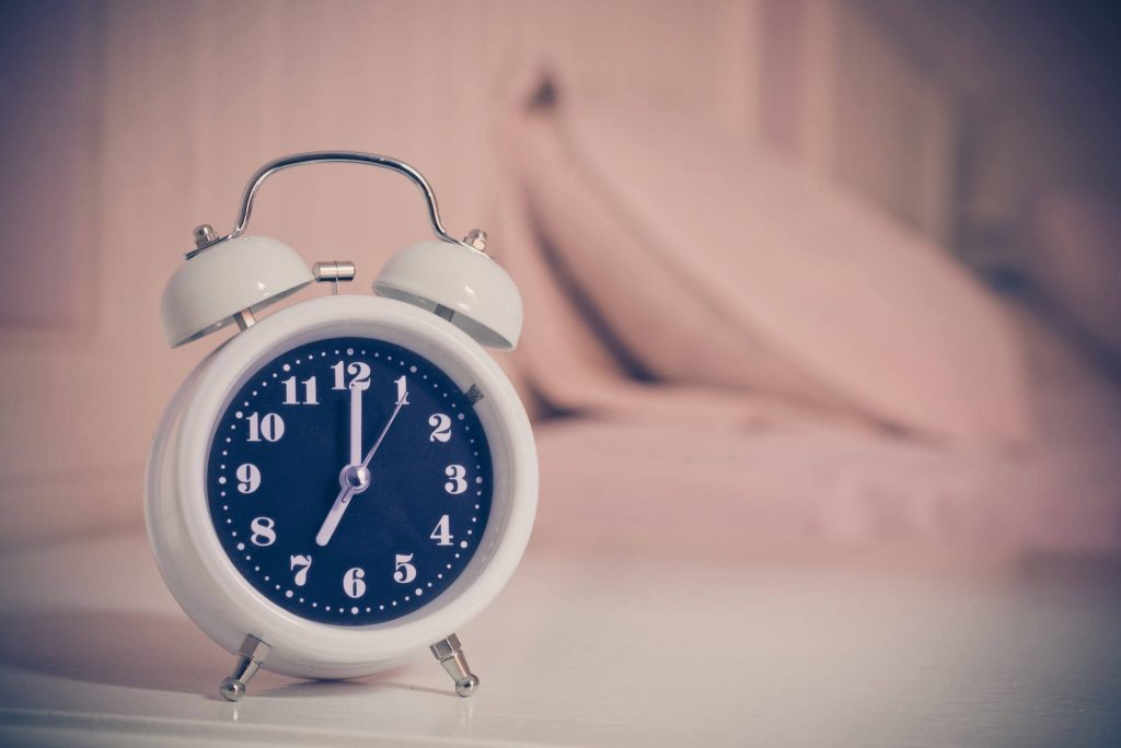 Alarm clock on the bed