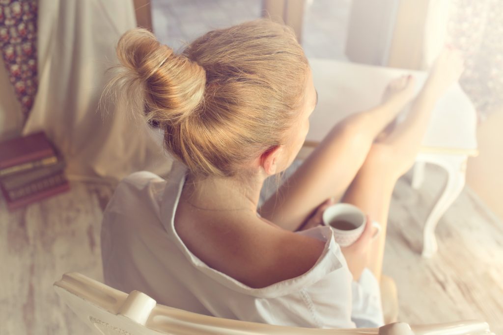 Girl relaxing with a cup basil tea