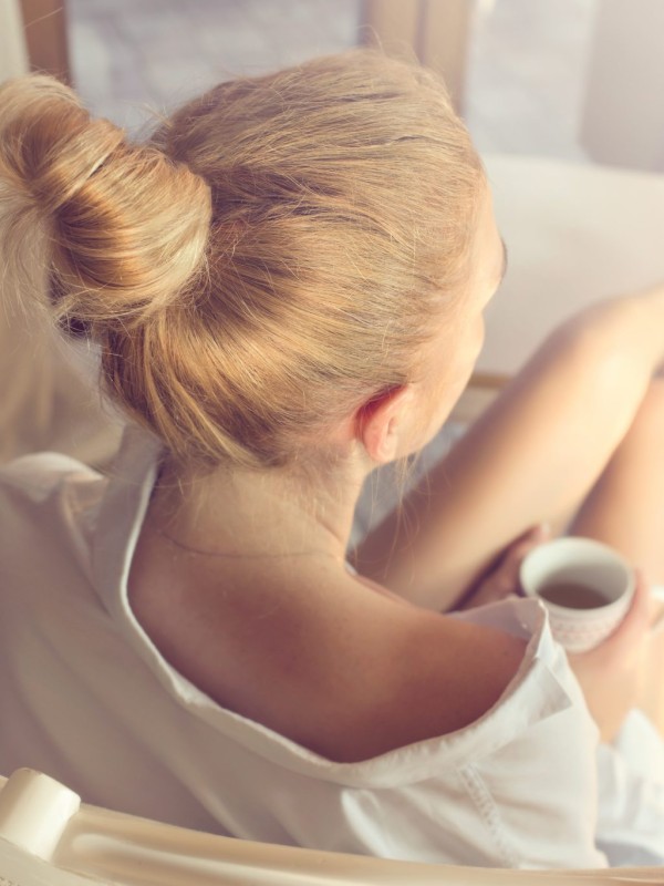 Girl relaxing with a cup basil tea