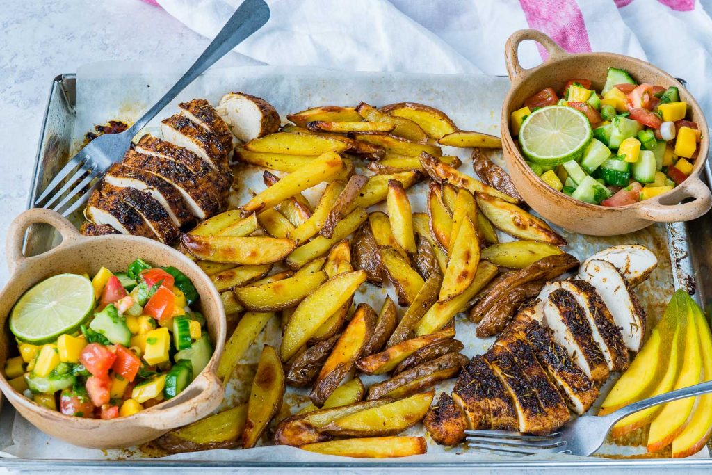 Clean Eating Sheet Pan Jerk Chicken with Baked Fries + Fresh Mango Salsa
