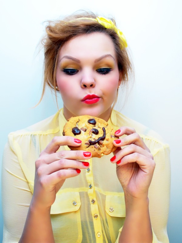 Girl craving to eat a cookie with a smiley