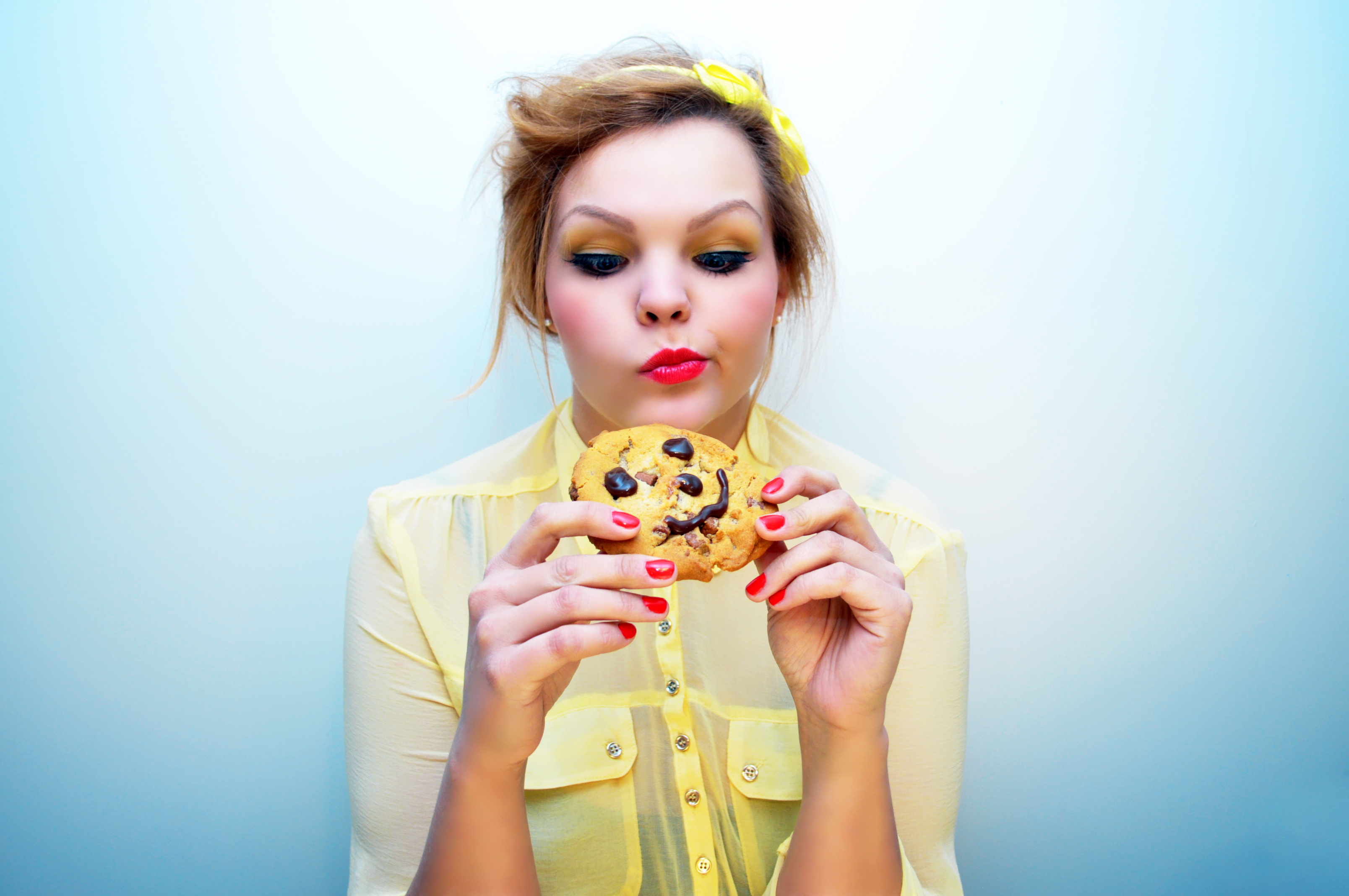 Girl craving to eat a cookie with a smiley