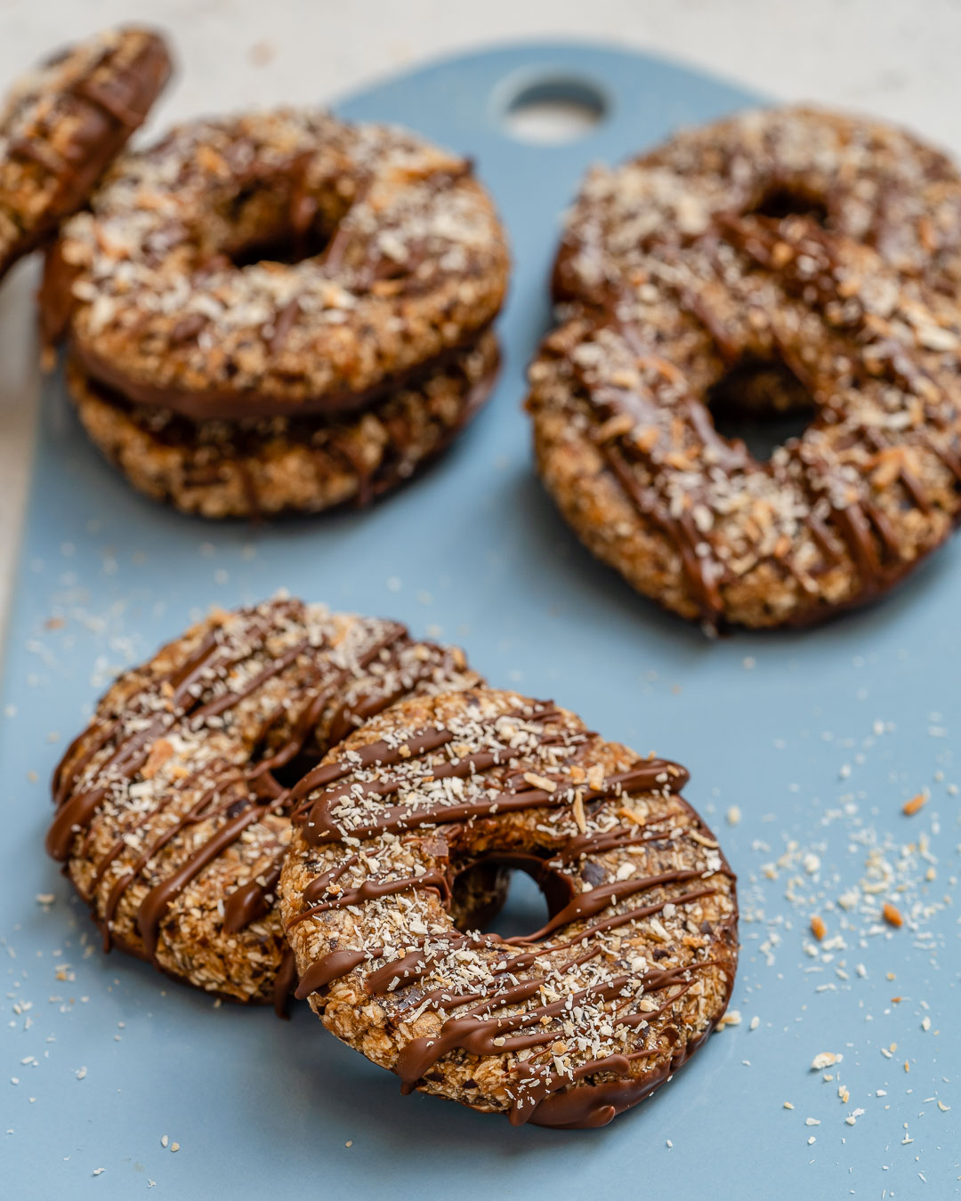 Samoa cookies drizzled with chocolate and sprinkled with coconut flakes.