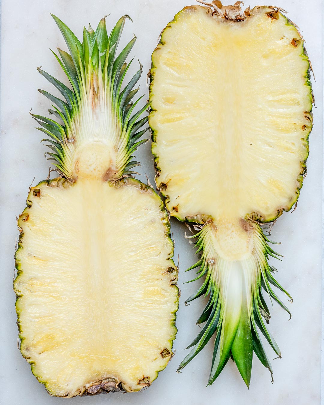 A pineapple cut in half to make pineapple chicken bowls.