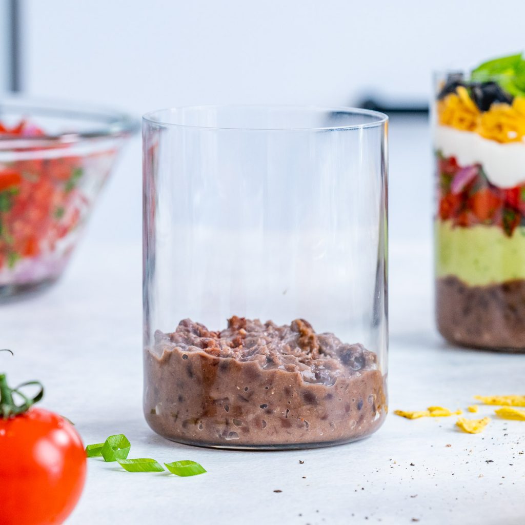 Bean layer in 7 layer dip cup.