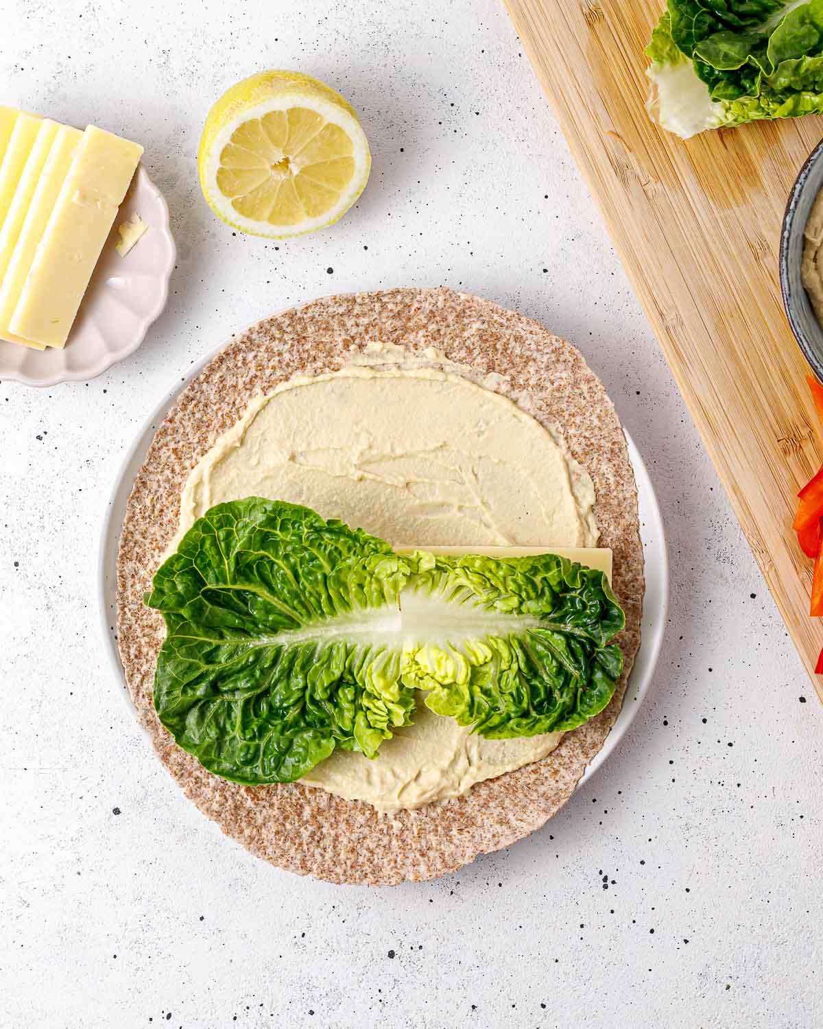 https://cleanfoodcrush.com/wp-content/uploads/2023/07/Rainbow-Veggie-Hummus-Wraps-Step-4.jpg