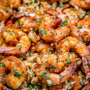 Close up image of Cajun shrimp and rice sprinkled with parsley.