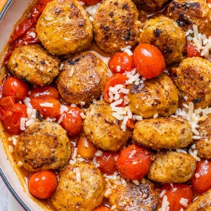 Cottage cheese meatballs with tomatoes and cheese in a bowl.