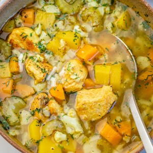 Chicken and Cauliflower Rice Soup in a bowl with a spoon.