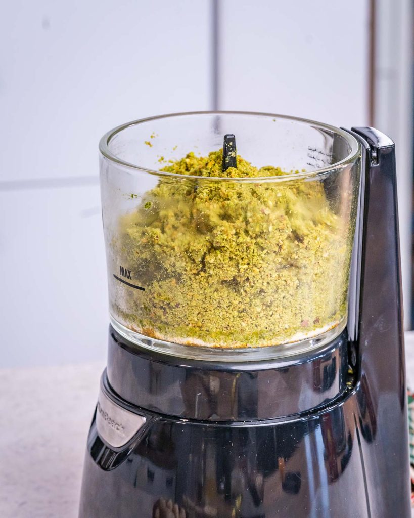 All ingredients for Christmas energy balls added to a food processor and processed until all mixed and green.