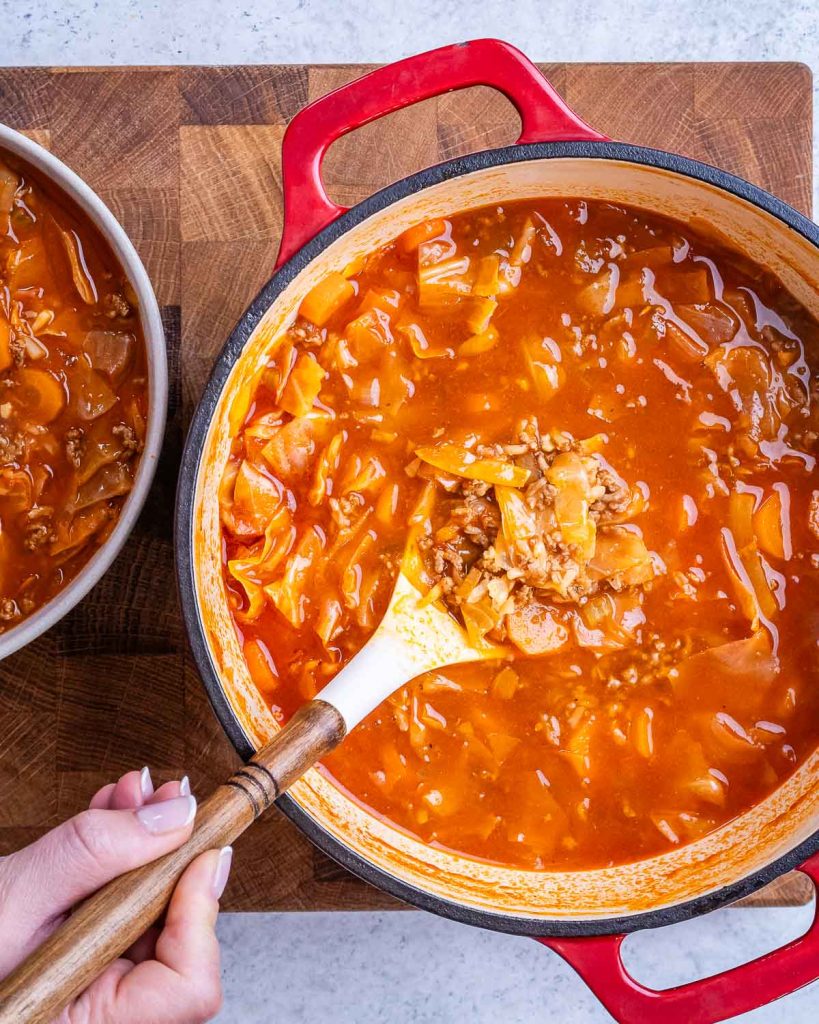 Unstuffed Cabbage roll soup being served using a spoon.