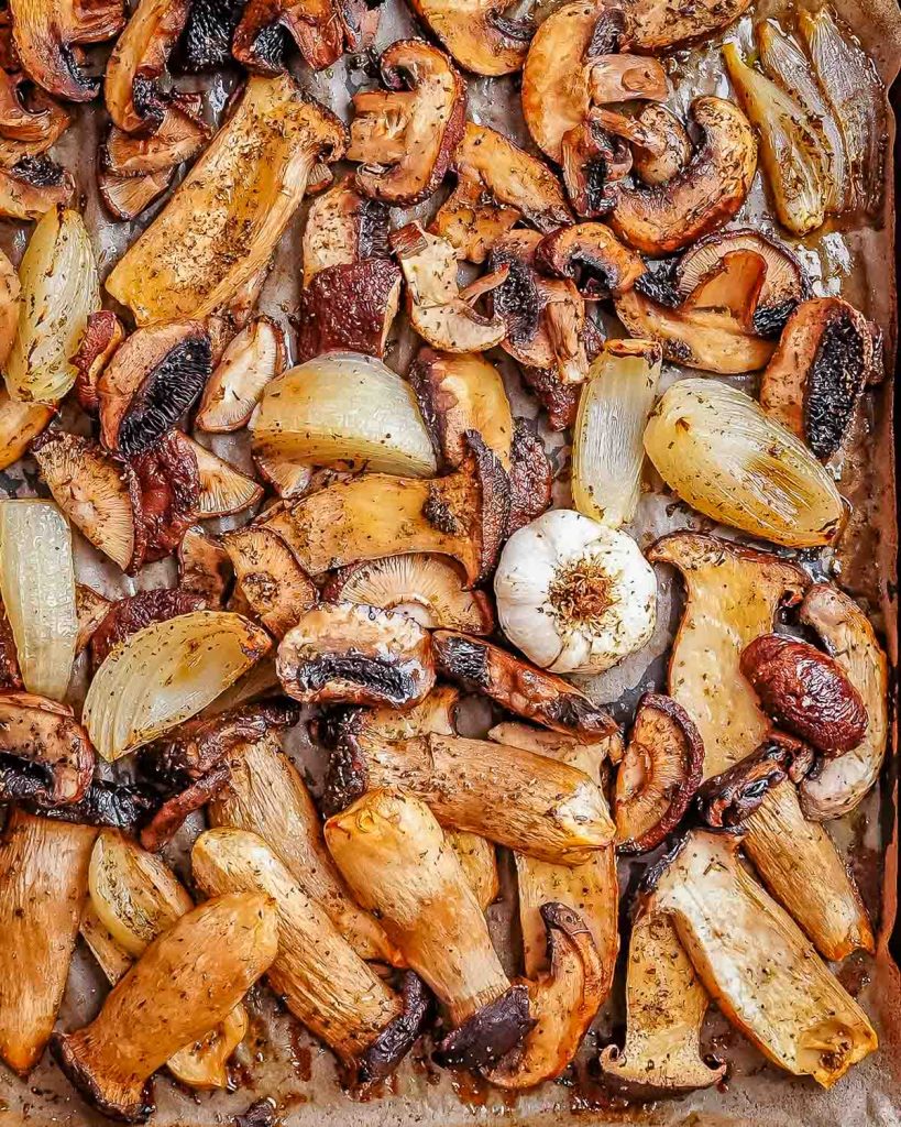 An assortment of chopped vegetables that have been roasted on a sheet pan.