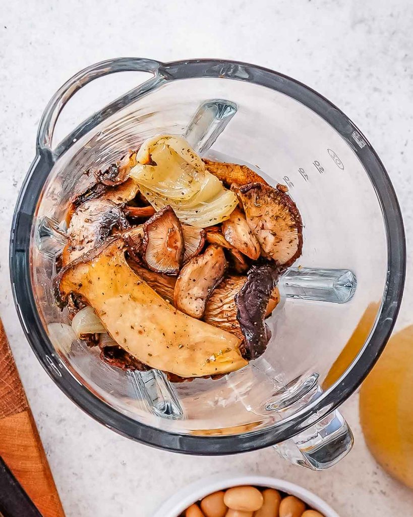 Chopped mushrooms and onions in a blender.