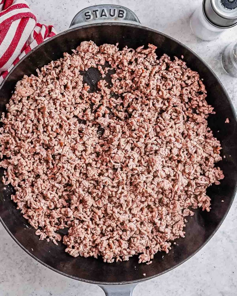 Ground beef cooked in a black skillet.