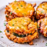 Image of zucchini lasagna bites on a white and tan speckled plate.