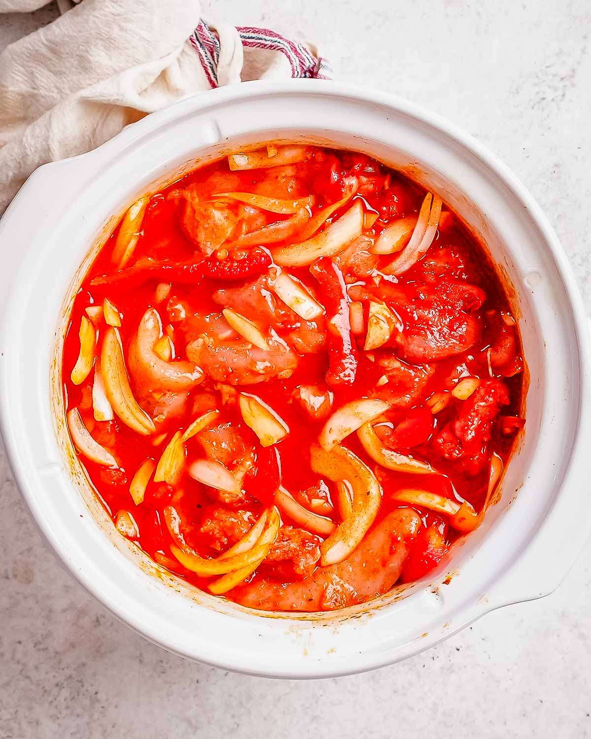 Chicken paprika cooking in a crockpot.