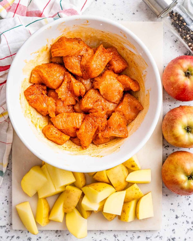 Diced turkey in a bowl and covered with seasoning powder to make turkey stew.