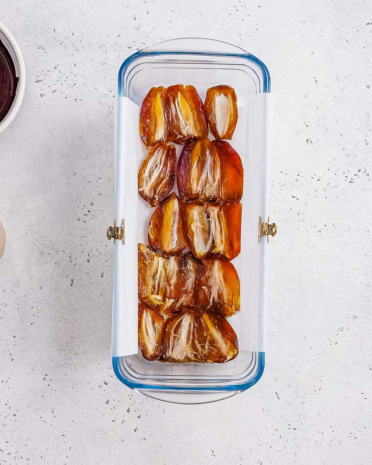 dates pressed in a loaf pan to make date snickers bars.