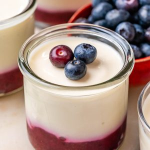 No-bake cottage cheese cheesecake cups topped with berry and chia puree.