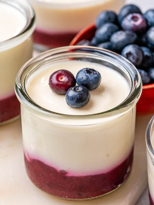 No-bake cottage cheese cheesecake cups topped with berry and chia puree.