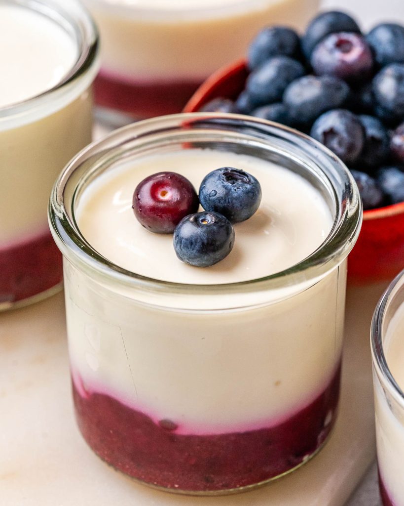 No-bake cottage cheese cheesecake cups topped with berry and chia puree.