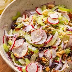 Fresh celery salad with orange vinaigrette in a bowl.