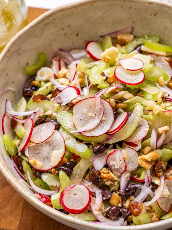 Fresh celery salad with orange vinaigrette in a bowl.
