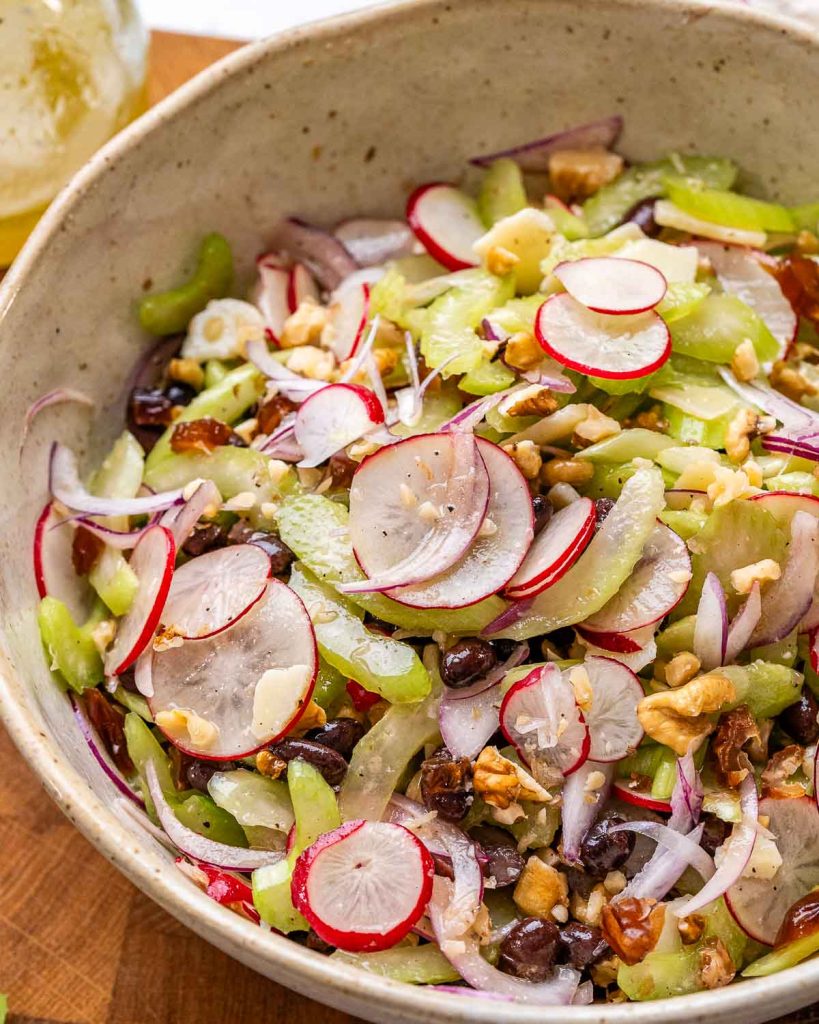 Fresh celery salad with orange vinaigrette in a bowl.