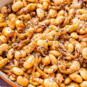 French onion butter beans in a skillet.