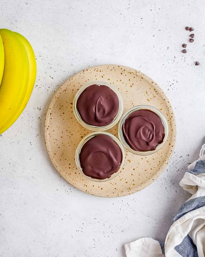 cottage cheese banana pudding cups with chocolate hard shell topping.