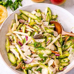 asparagus salad recipe in a bowl with a spoon.