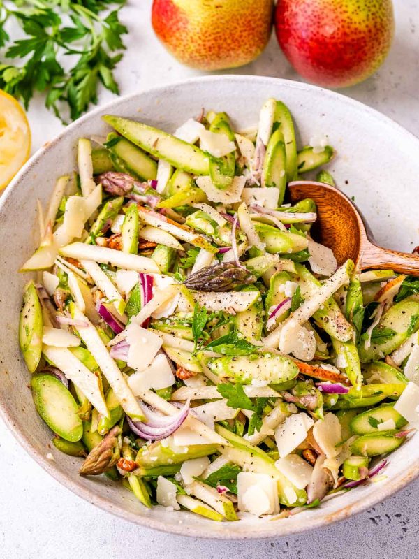 asparagus salad recipe in a bowl with a spoon.