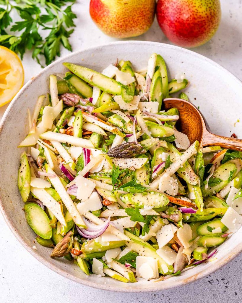 asparagus salad recipe in a bowl with a spoon.