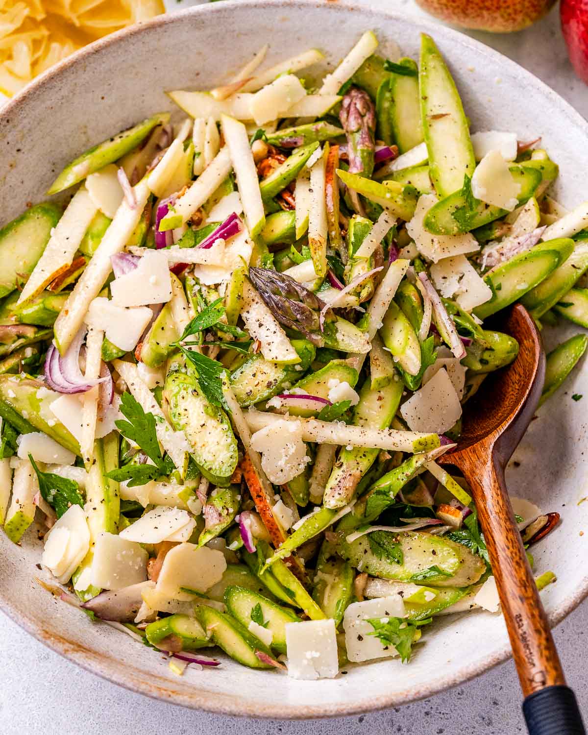image of a salad with asparagus, pears, pecans, parmesan cheese, and lemon dressing.